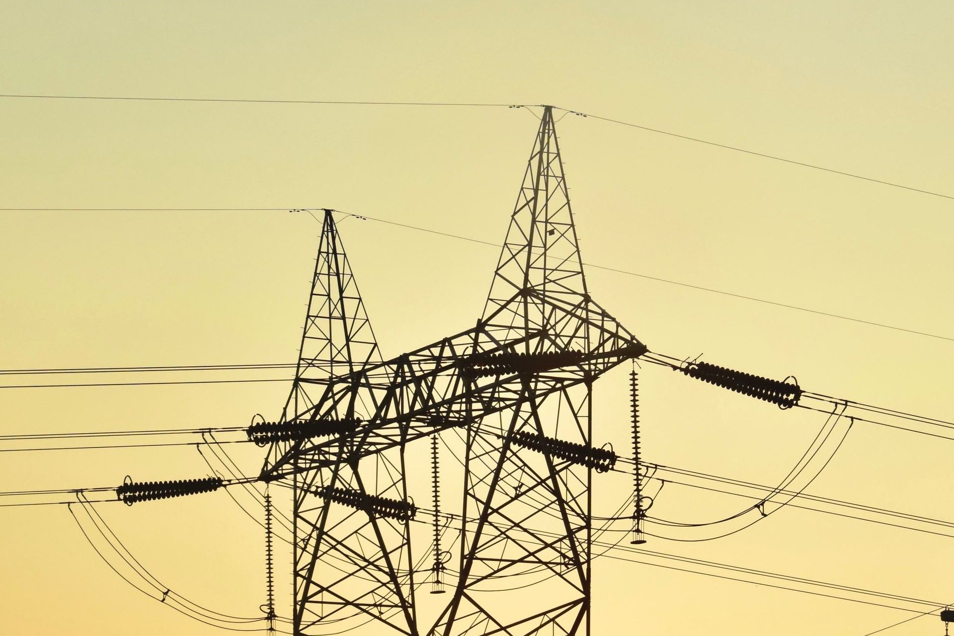 Power transmission lines silhouetted at sunset