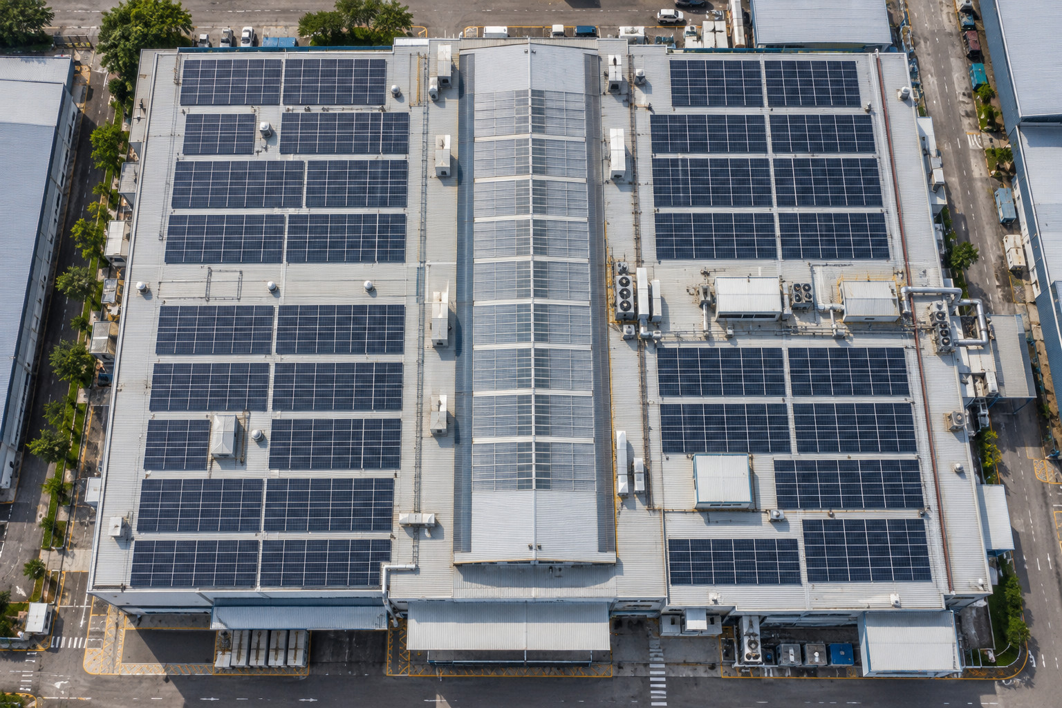 Aerial view of solar panels on a factory roof
